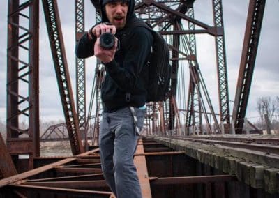 justin hallberg with camera on a bridge