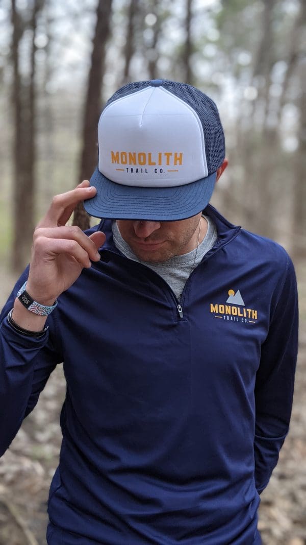 cory logsdon in the monolith foamie trucker hat and spring quarter zip